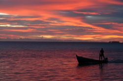Sunset in the Maldives. This fisherman brought his catch ... by Grant Kennedy 